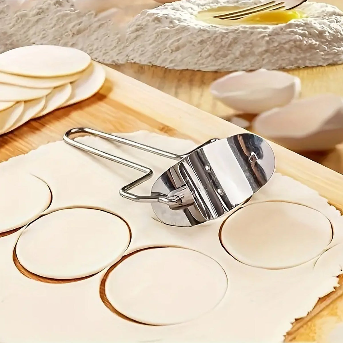 Stainless steel puri cutter roller with comfortable handle on a clean surface. Main image