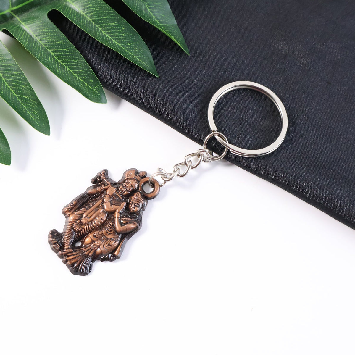 Radha Krishna metal keychain with antique finish and intricate design Main image