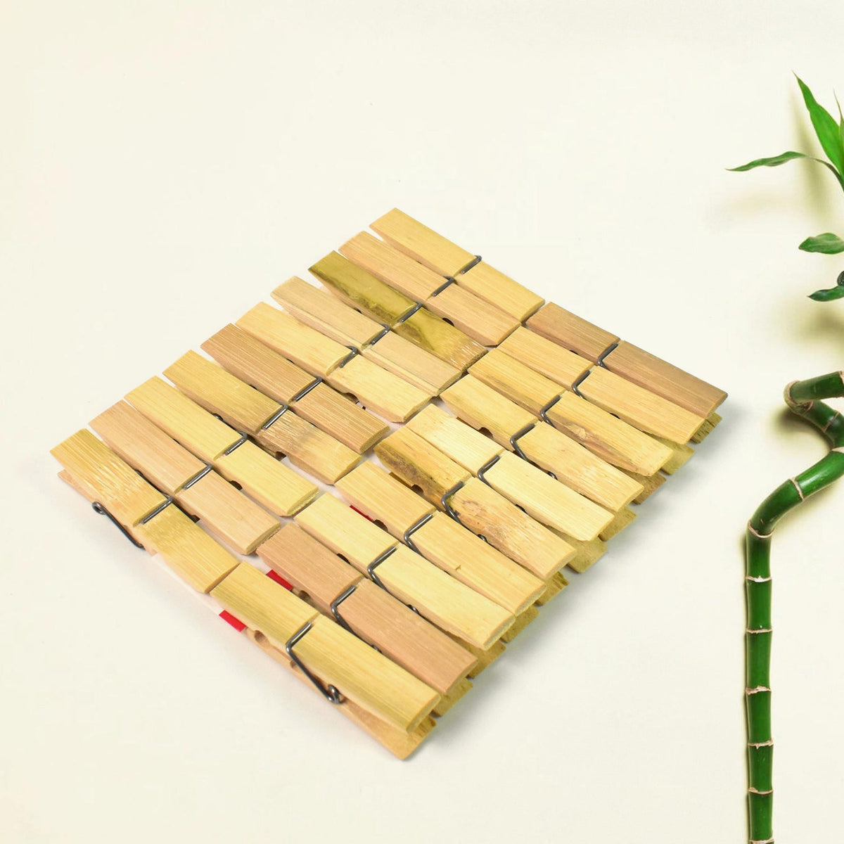 Strong bamboo cloth clips holding various garments on a clothesline, ideal for laundry. Main image