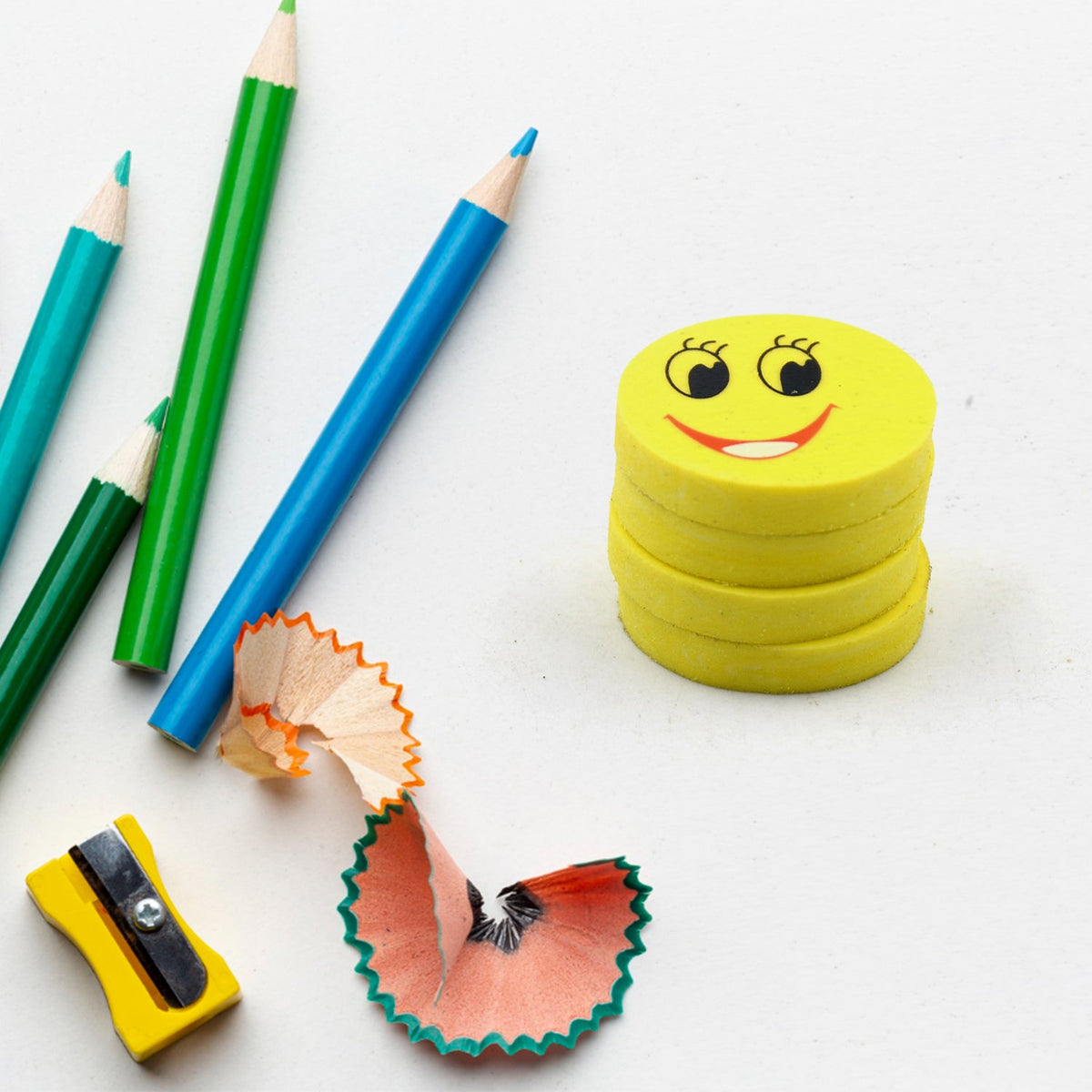 Four vibrant smiley emoji erasers, perfect for kids' school supplies. Main image