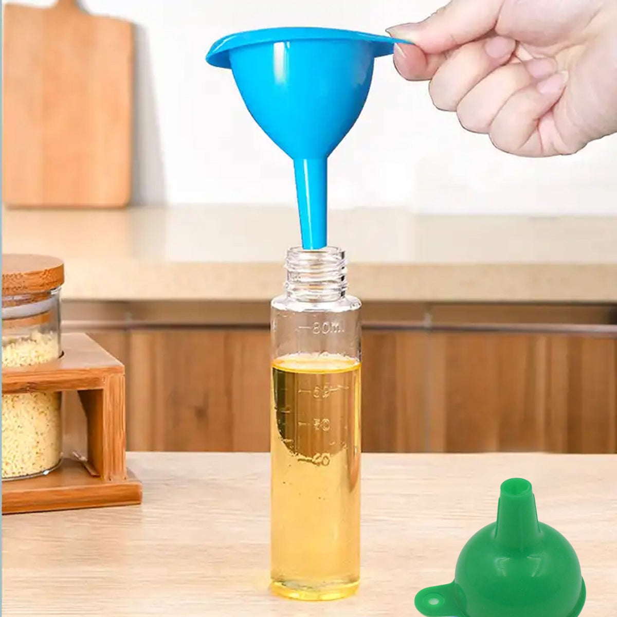 Green silicone funnel making liquid transfer easy in a modern kitchen setup. Main image