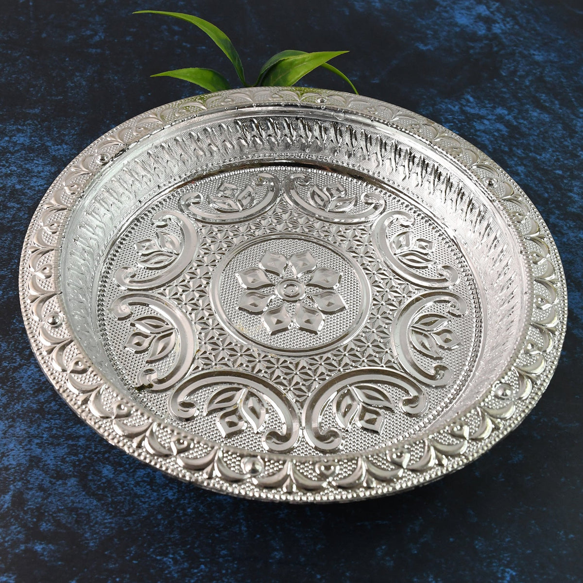 Silver finish plastic pooja thali with embossed floral design on surface Main image