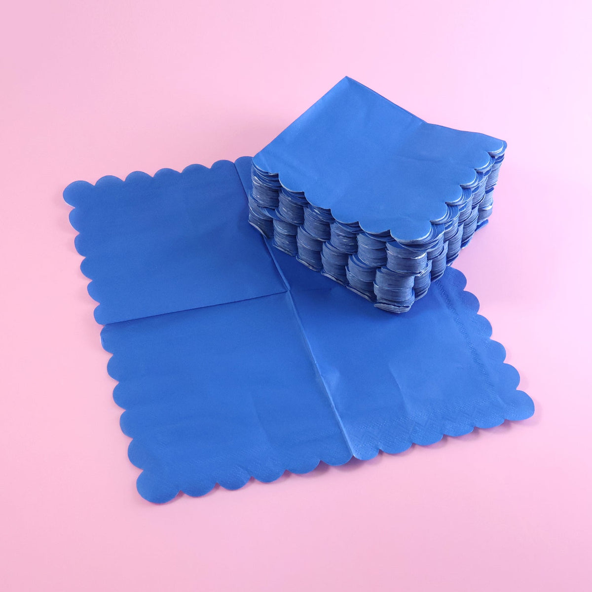 Royal scalloped paper napkin with elegant scalloped edges on party table Main image