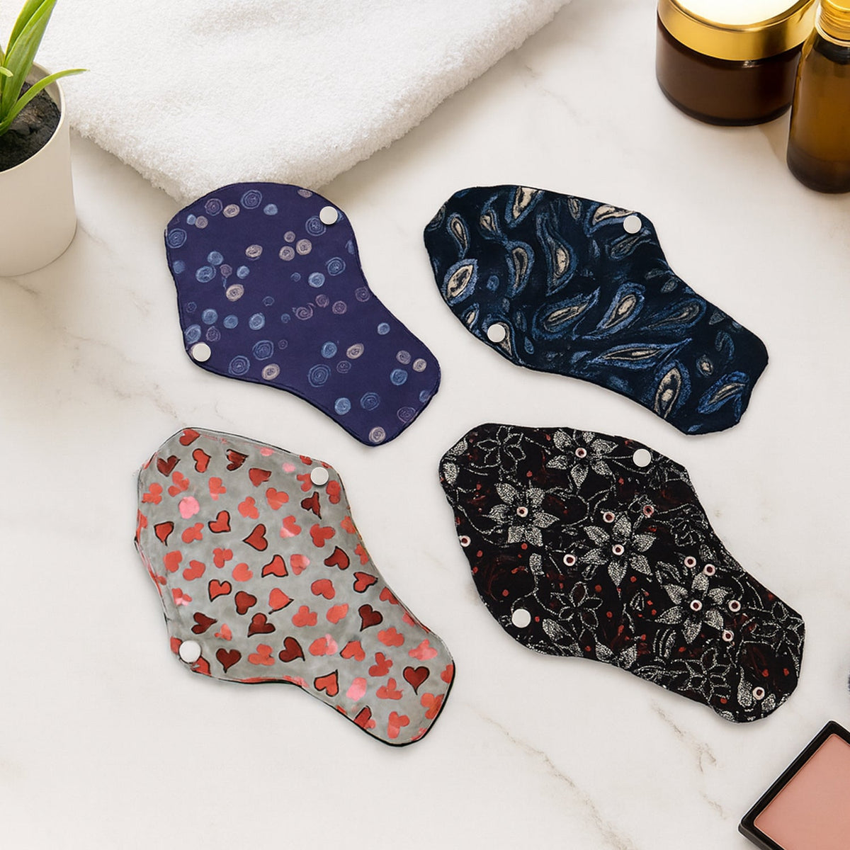 Set of reusable cloth sanitary pads in assorted prints providing eco-friendly menstrual protection Main image
