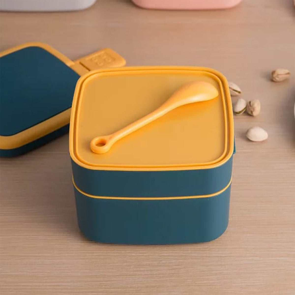 Vibrant blue double-layer bento lunch box with an integrated handle and spoon. Main image