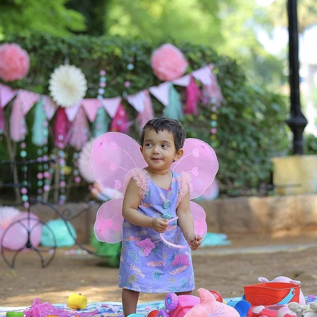 Baby girl wearing multi-color butterfly wings with a matching wand and hairband. Main image