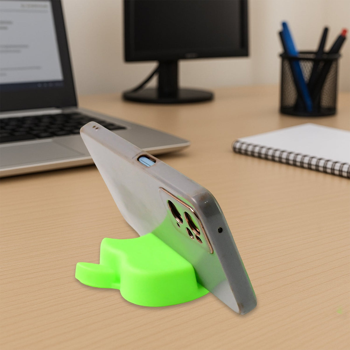 Apple-shaped plastic mobile phone stand set in assorted colors on a desk Main image