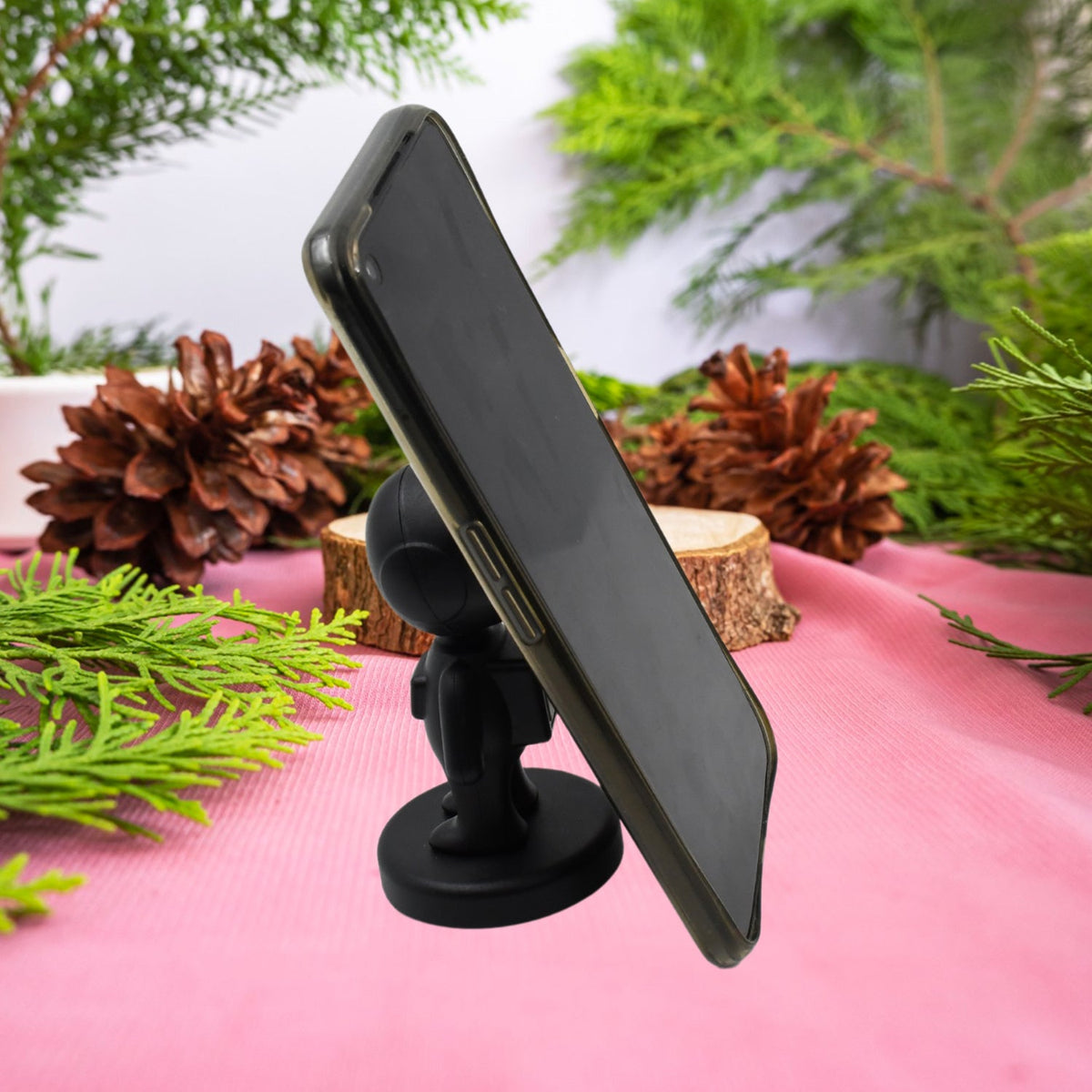 Cartoon Astronaut Magnetic Phone Holder securely mounted on a car dashboard for hands-free use. Main image