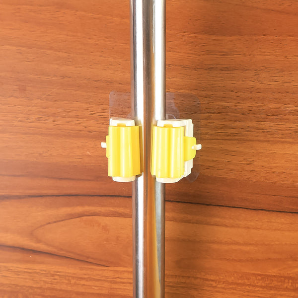 Detailed diagram showing the installation steps for the self-adhesive mop holder.