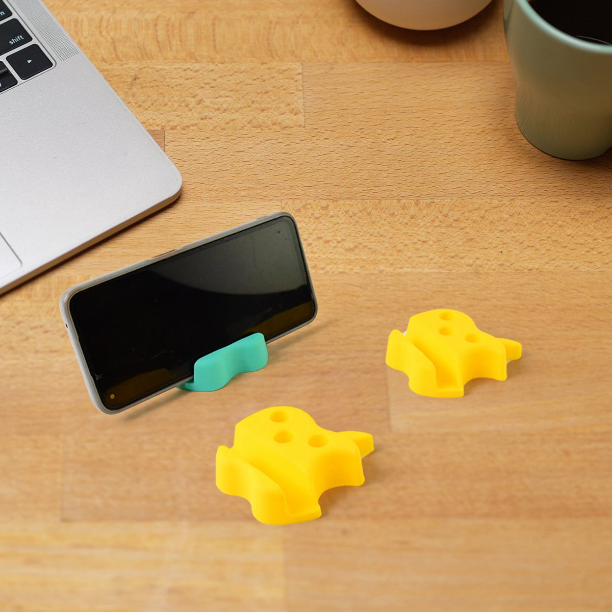 Apple-shaped plastic mobile stand with built-in pen holder on desk Main image