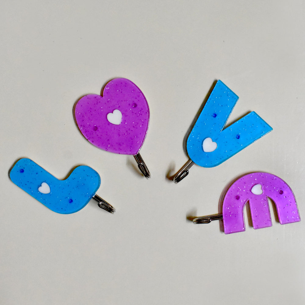 Love shape self adhesive hooks in white, mounted on a wall. Main image