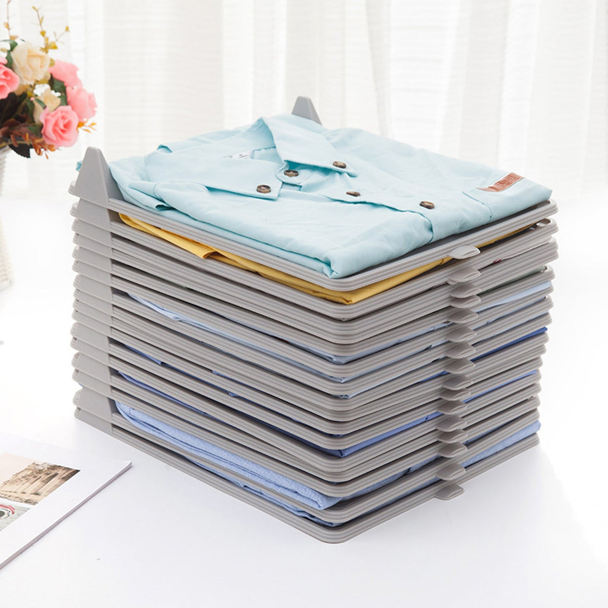 Compact plastic cloth organizer with folded garments, ideal for ironing shops. Main image