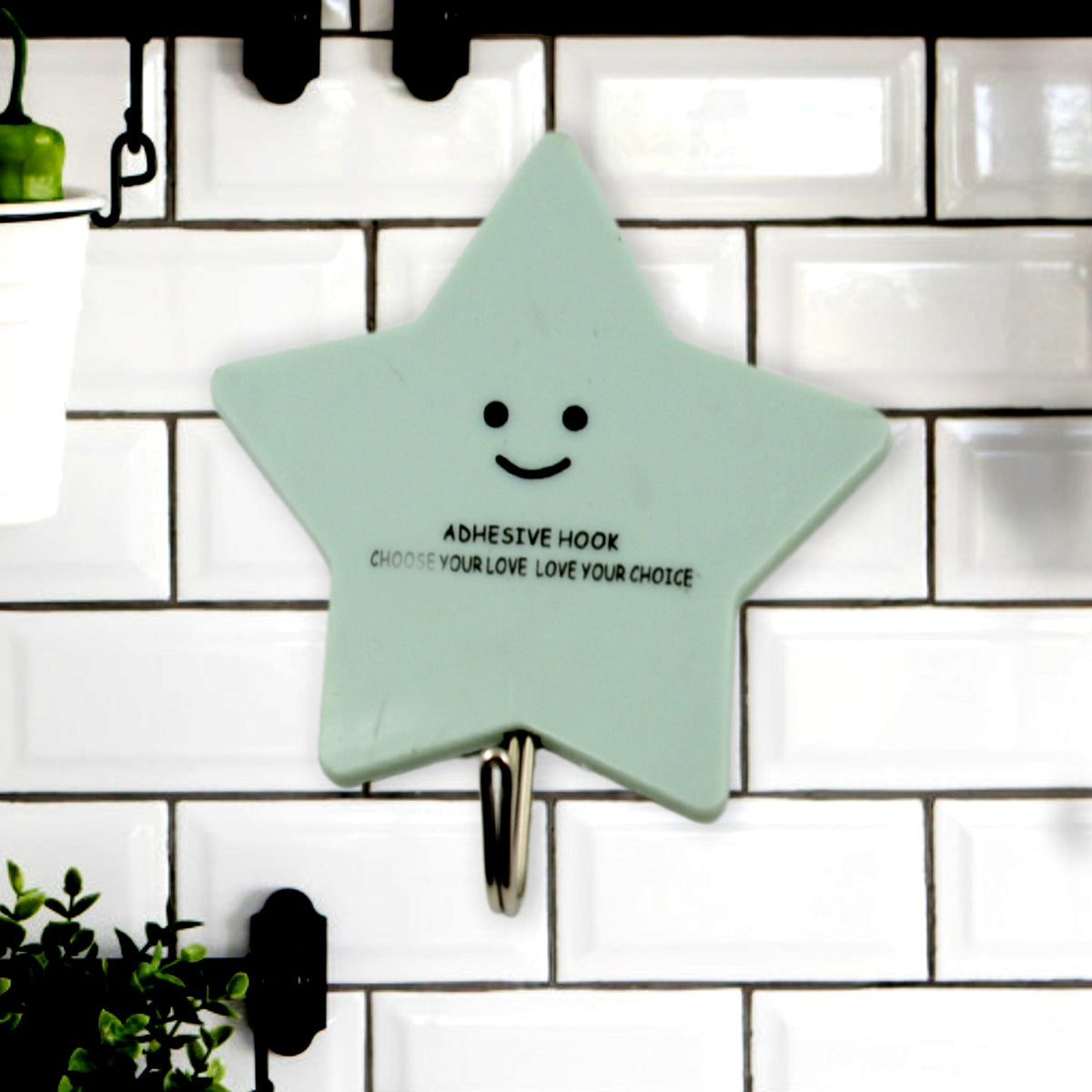 A set of strong self-adhesive hooks displayed neatly on a tiled kitchen wall, ready for use. Main image
