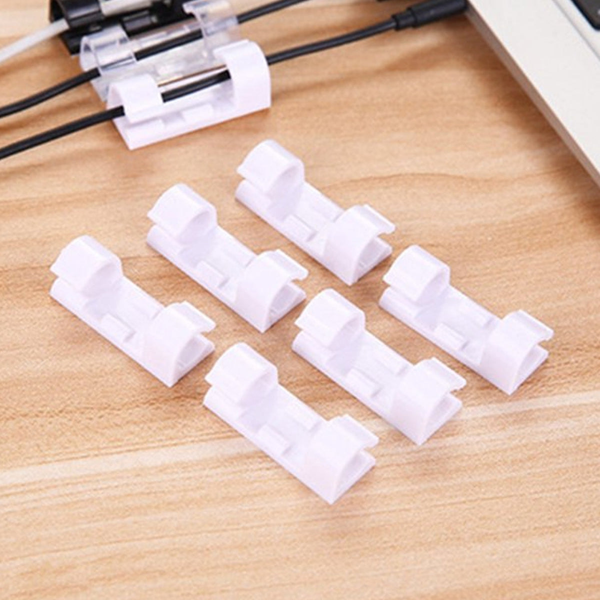 A set of white plastic cable clips with strong adhesive backing displayed on a clean surface. Main image