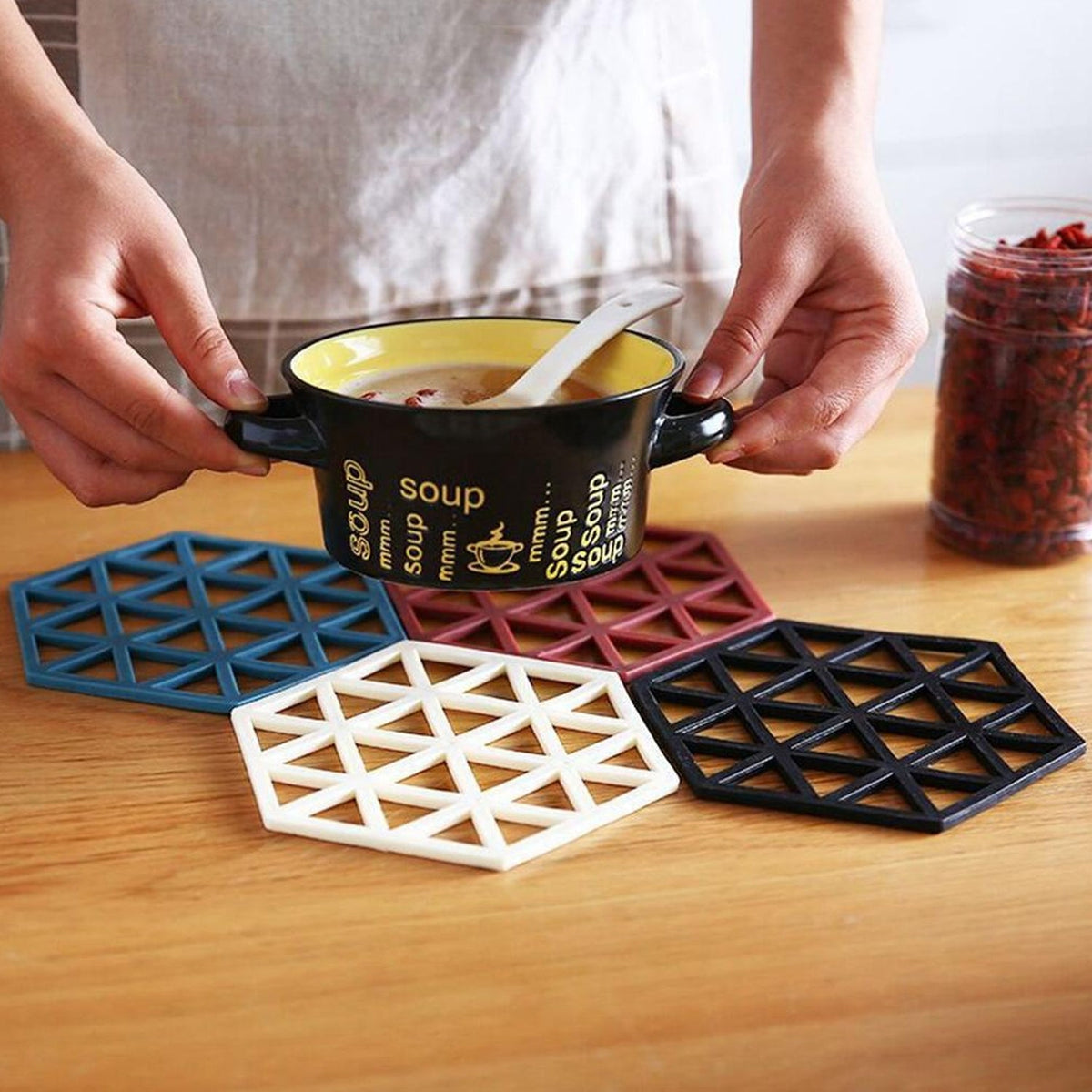 Black PVC tea coaster offering excellent heat insulation on a wooden table. Main image