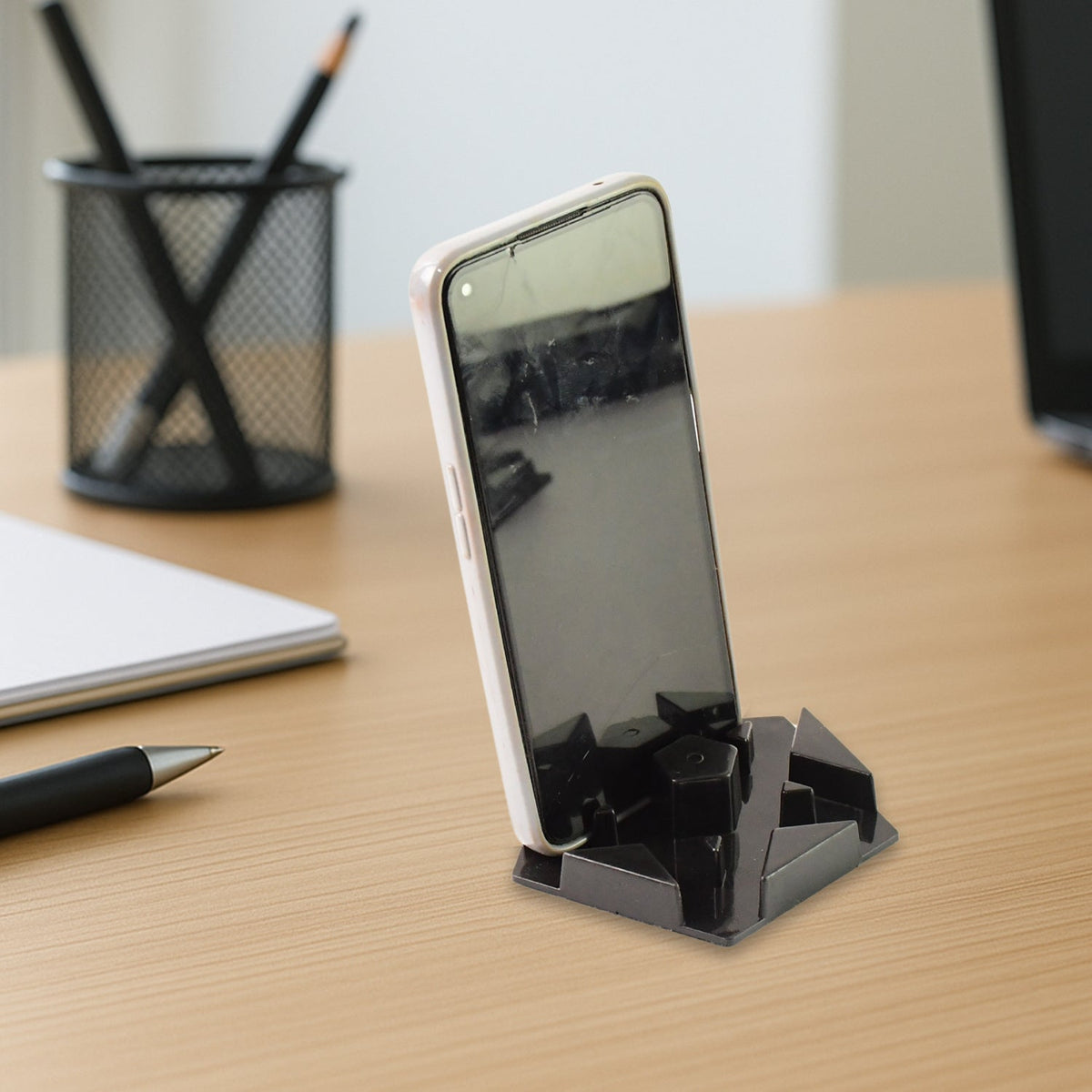 Hexagonal multi-angle mobile phone stand in use with phone Main image