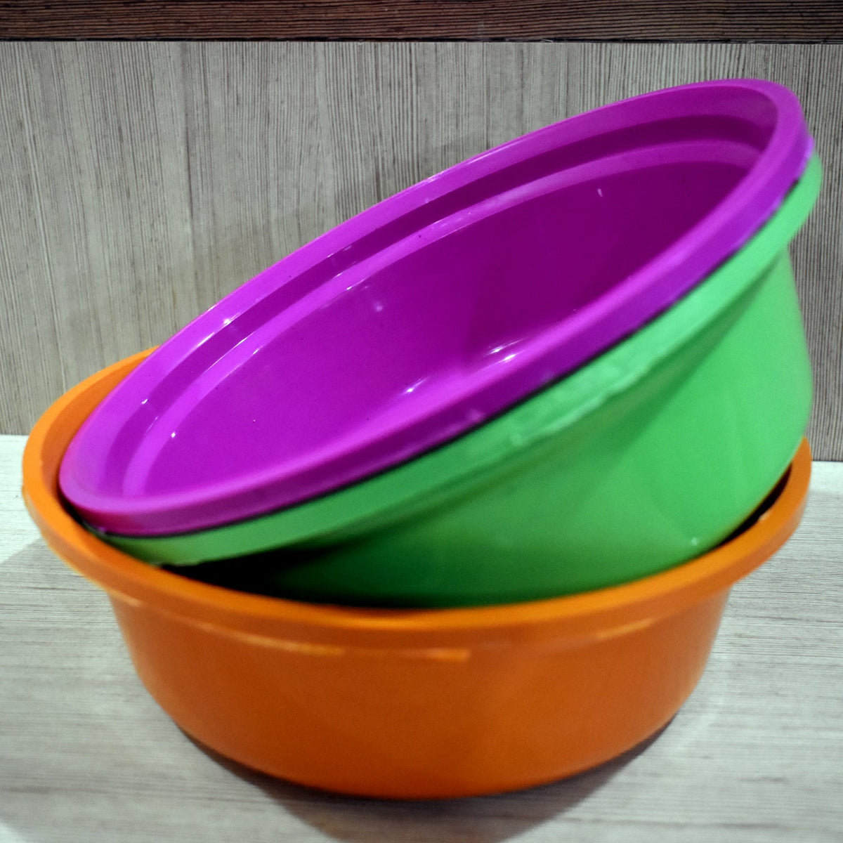 Set of three durable round plastic storage bowls for home use. Main image