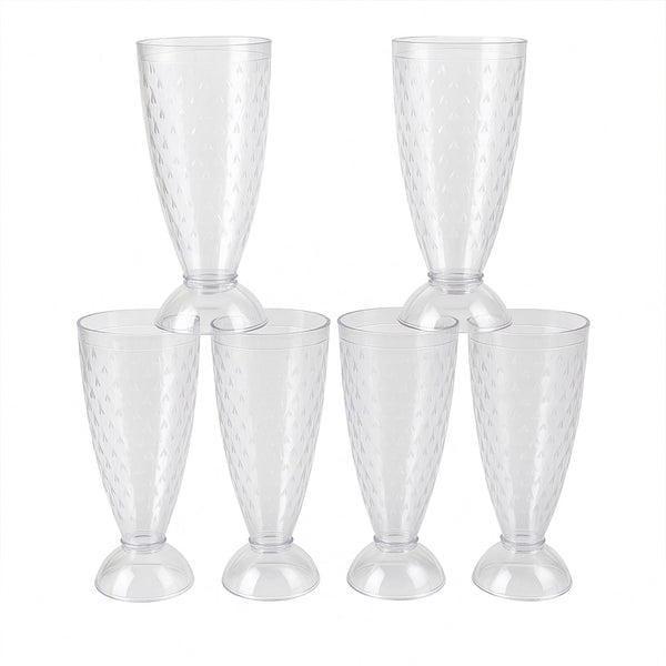 Transparent plastic milkshake glasses neatly arranged on a dining table