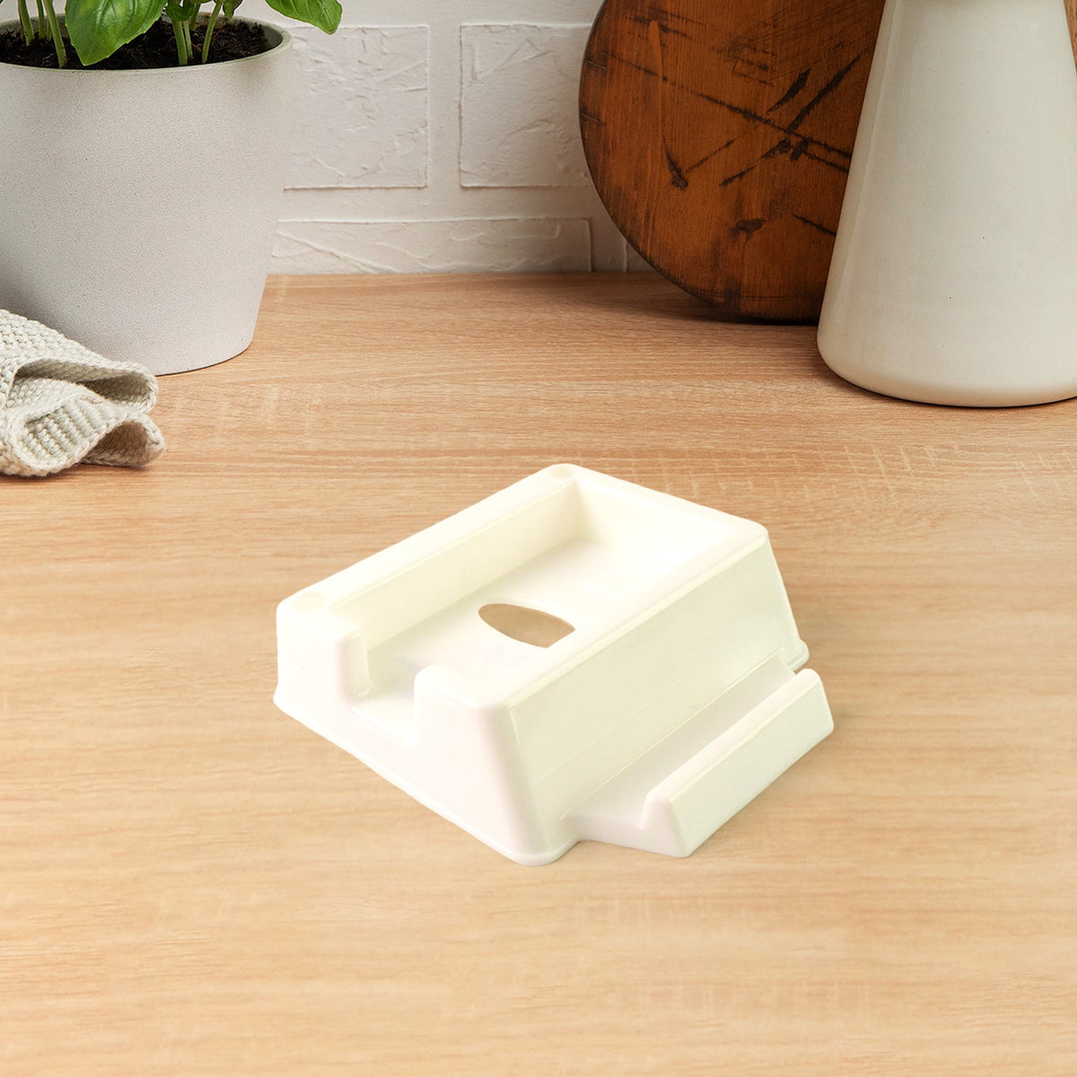 Plastic mobile phone stand mounted on wall with mobile and remote Main image