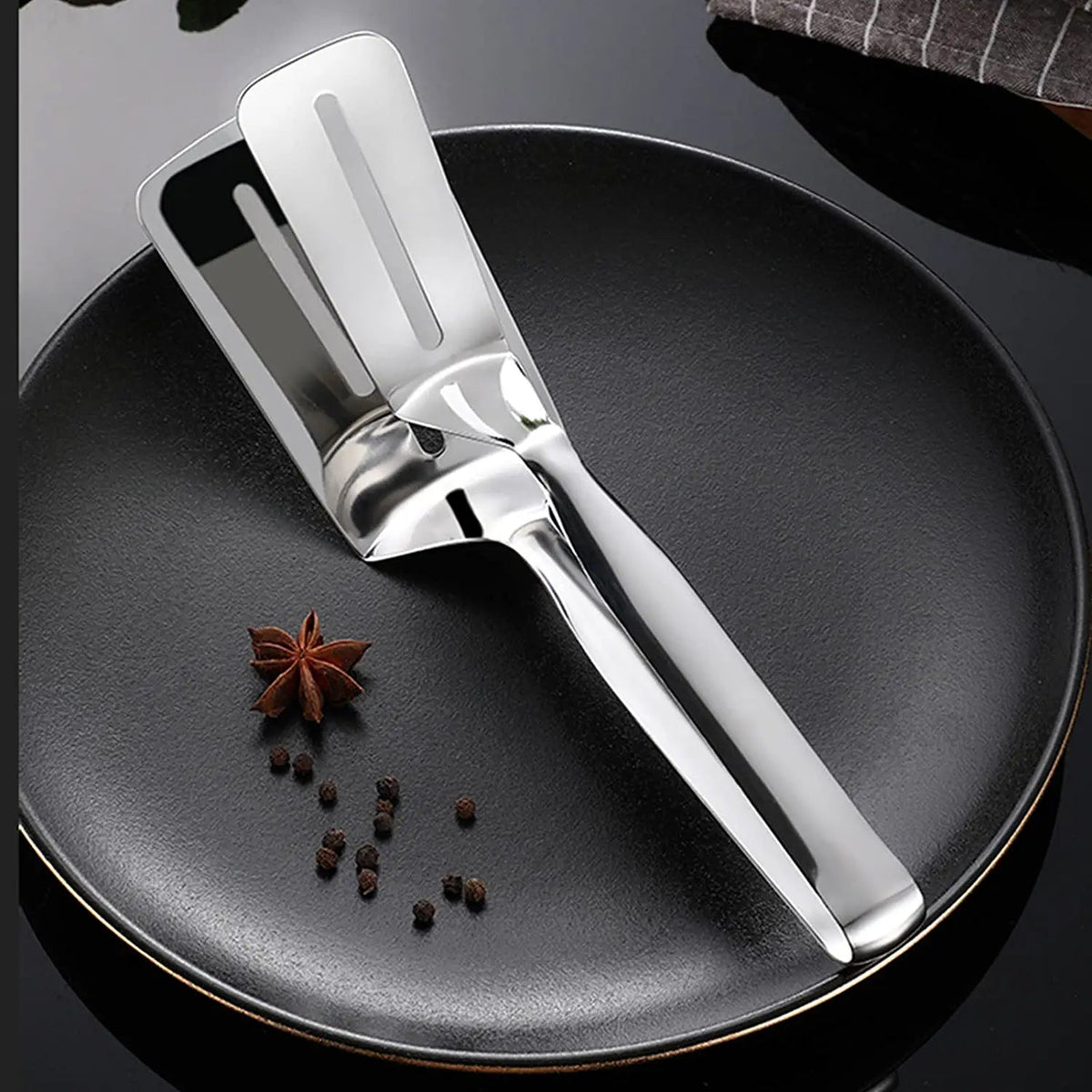 Stainless steel multifunction cooking tong with oil-draining slots. Main image
