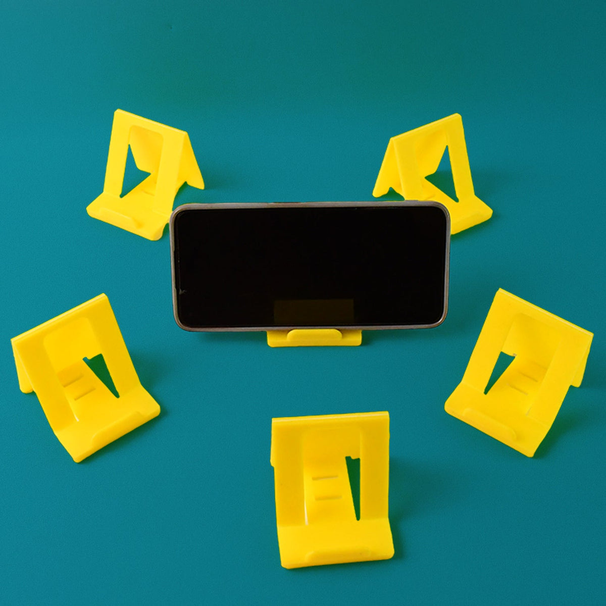 Foldable plastic mobile phone stand supporting a smartphone at an angle Main image