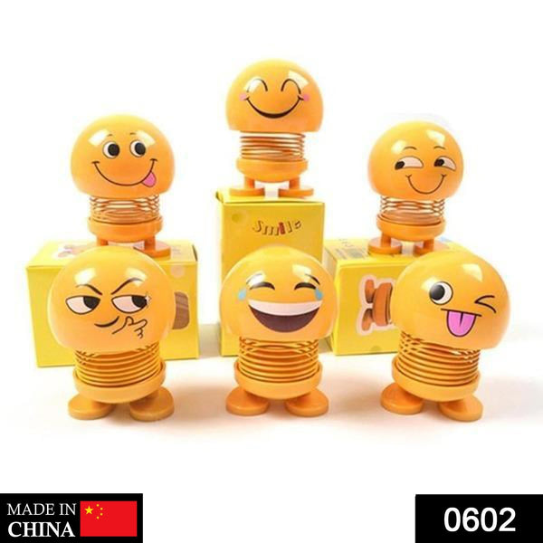 Front view of a funny bobblehead smiling face spring doll for desk decor.