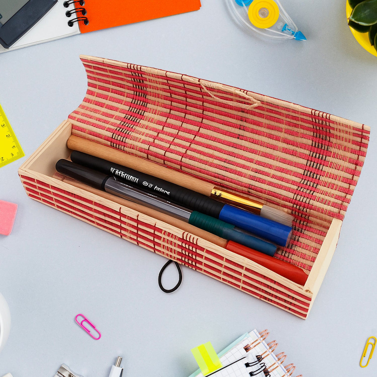 Handcrafted bamboo mat style pen and pencil box on a wooden surface Main image