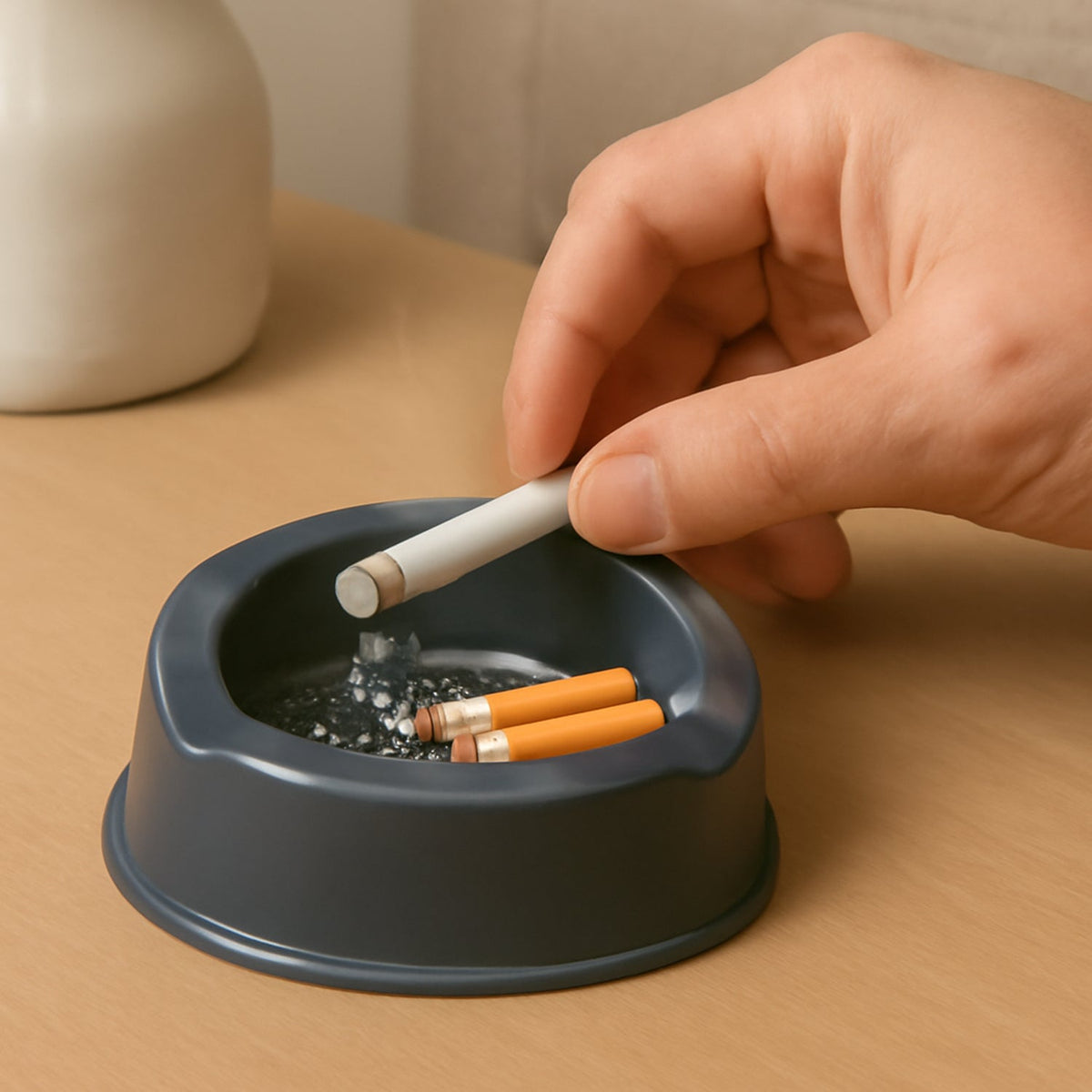 Durable grey plastic ashtray with wide bowl and triple cigarette slots Main image