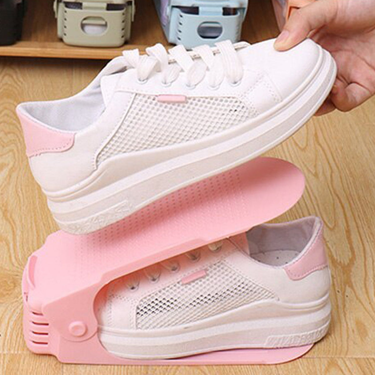 A multi-color adjustable shoe organizer neatly stacking a pair of sneakers. Main image