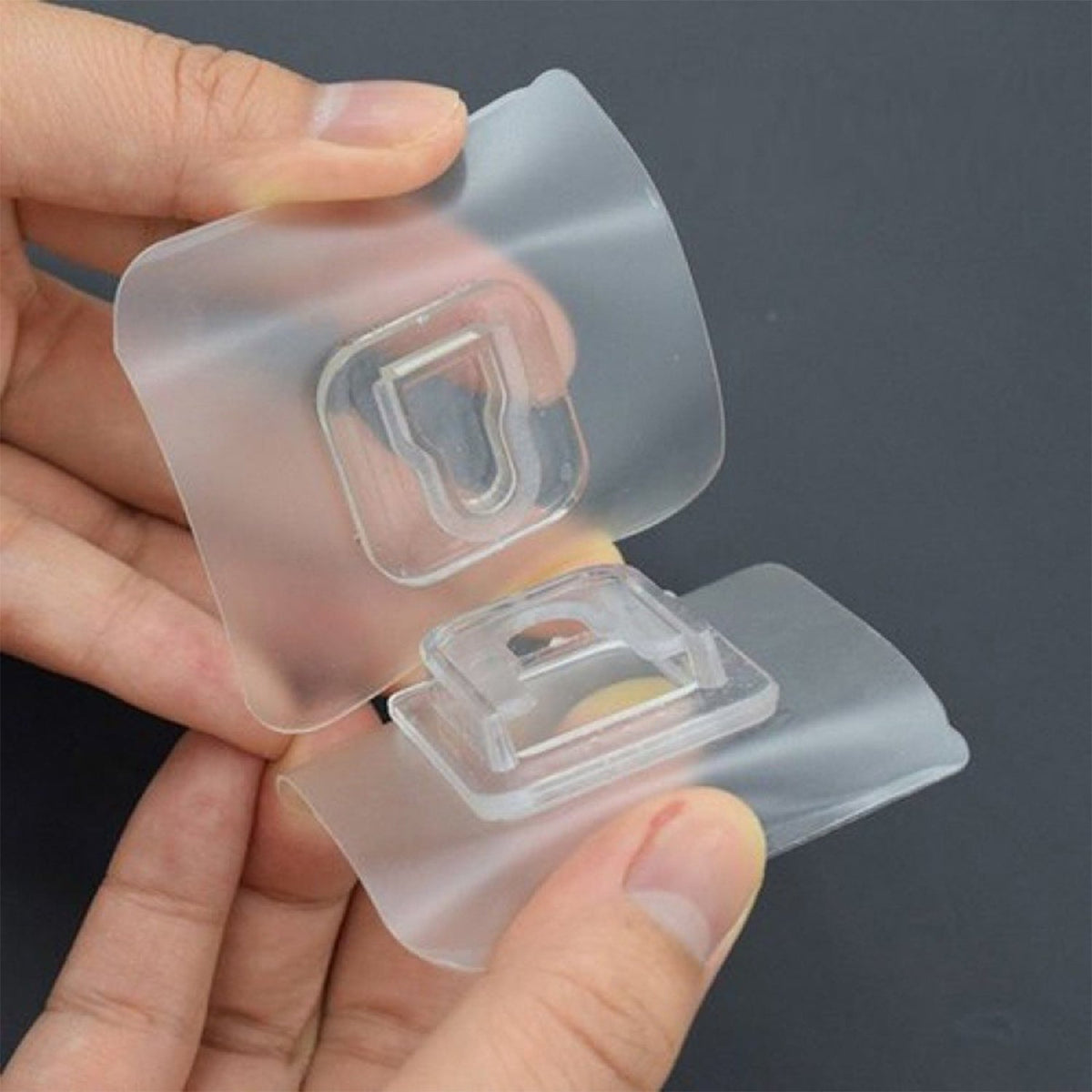 Self-adhesive transparent hook providing a strong hold on a clean wall. Main image