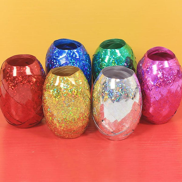 Multicolor curling ribbon rolls displayed for festive party decorations.