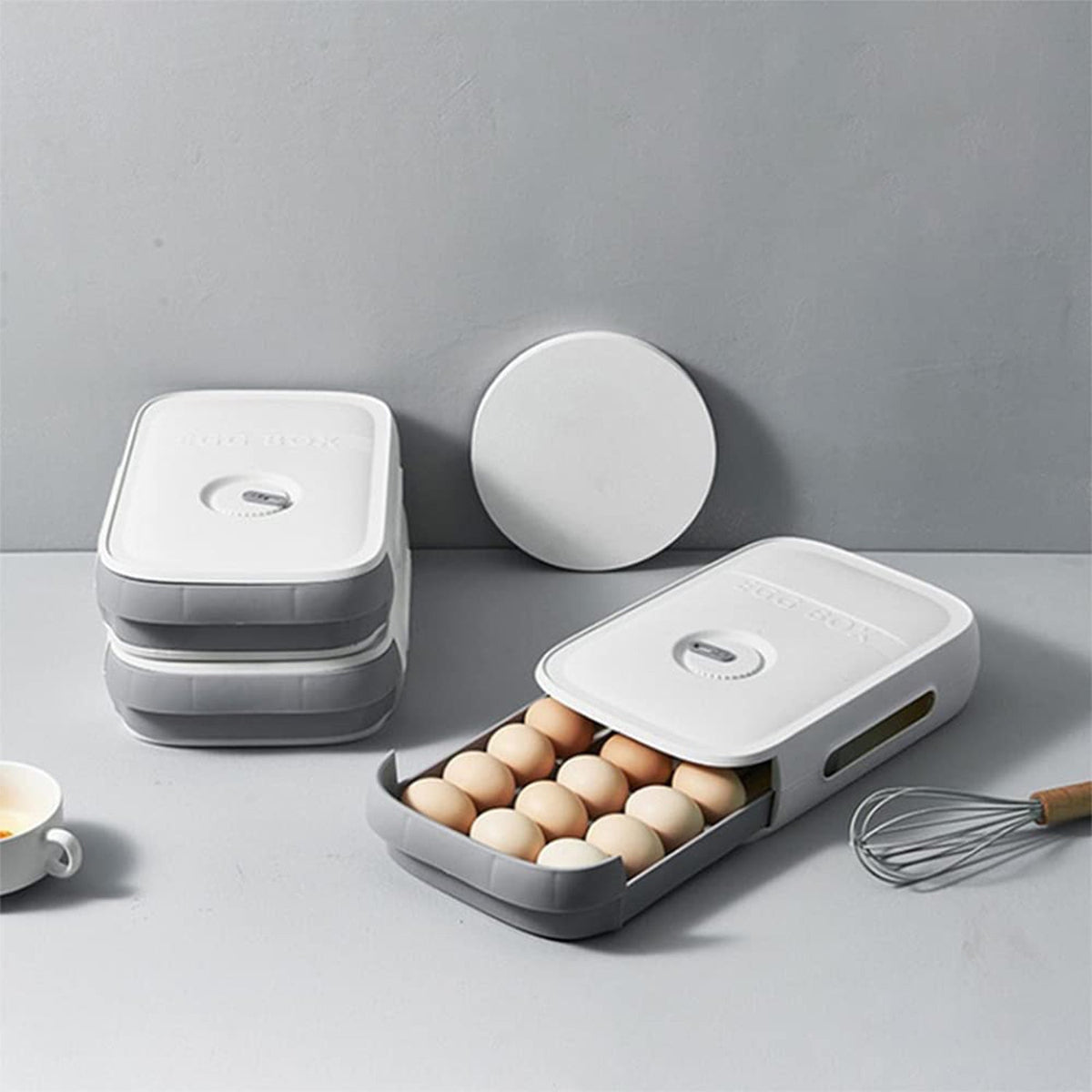 A clear plastic egg storage box with a drawer style, holding eggs inside a refrigerator. Main image