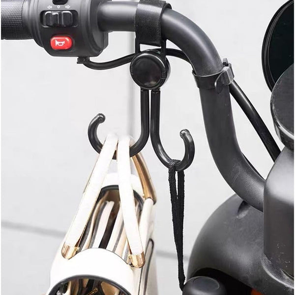 Multi-purpose stroller hook holding shopping bags and a purse on a pram.