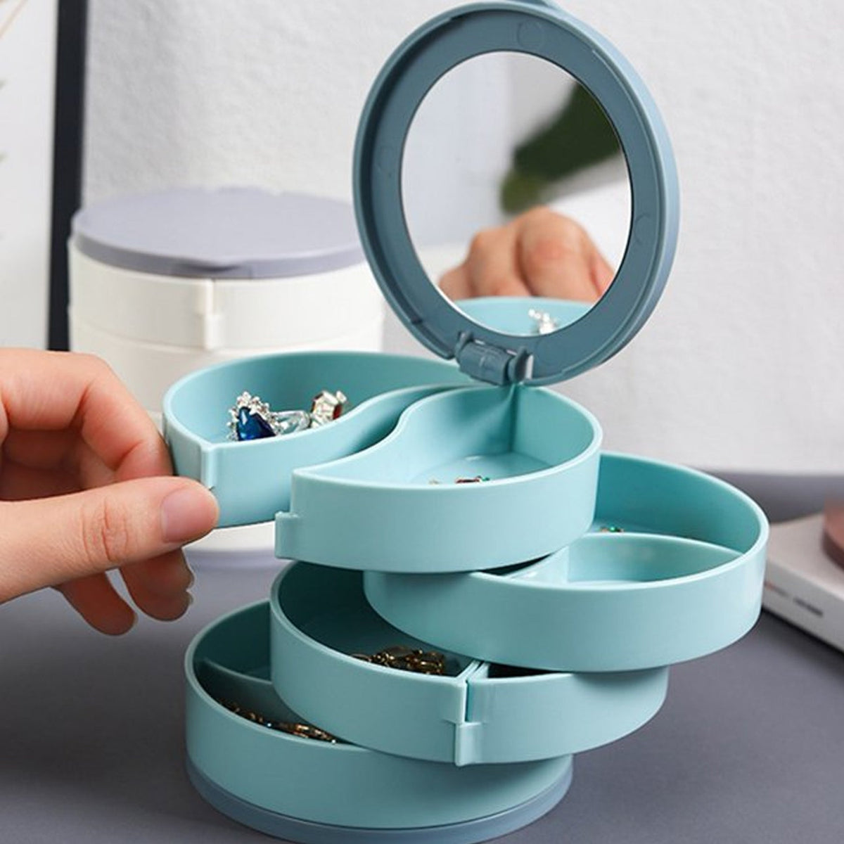 4-layer 360-degree rotating jewellery box with mirror for organized storage. Main image