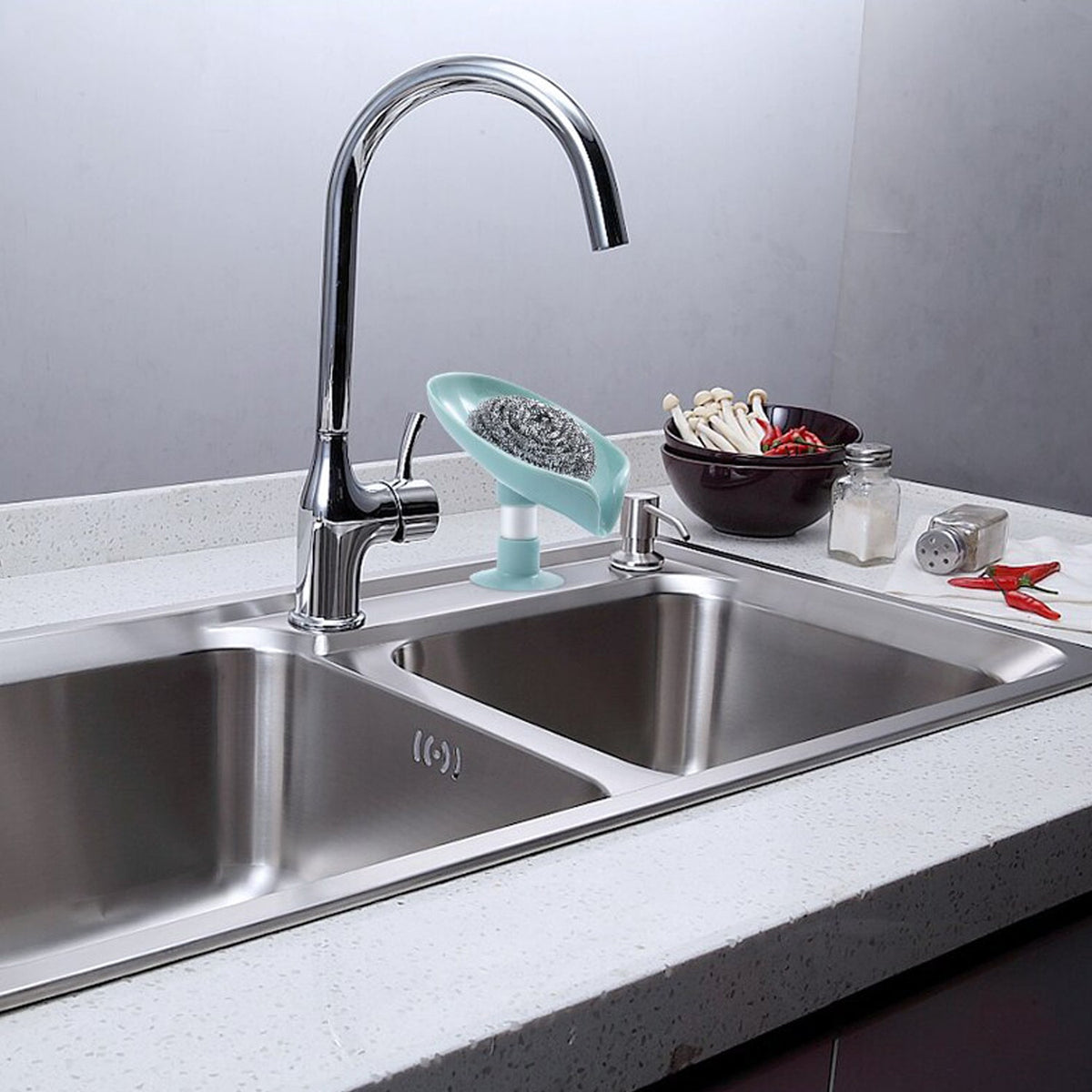 Self-draining leaf-shaped plastic soap holder in a clean bathroom setting. Main image