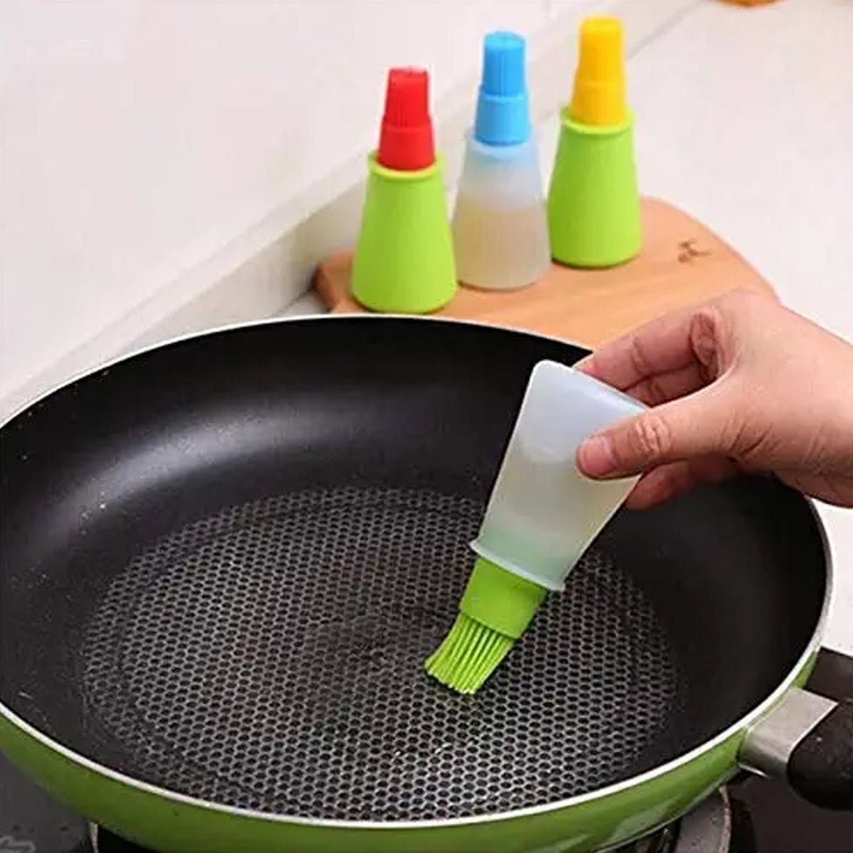 Silicone oil dispenser bottle with integrated basting brush for easy cooking. Main image