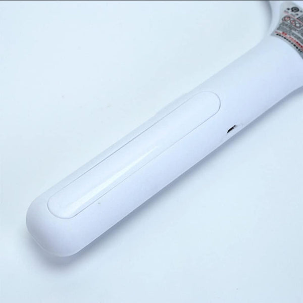 A close-up view of the smooth, white handle of the mosquito killer racket against a plain white background.