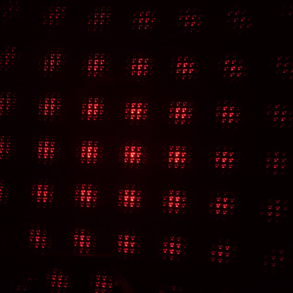 A galaxy projector creating a romantic starry night effect in a dimly lit room.