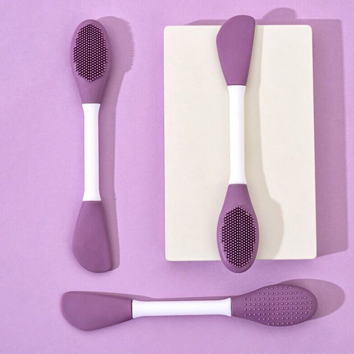Double-headed silicone mask brush with a pink silicone head and white handle. Main image