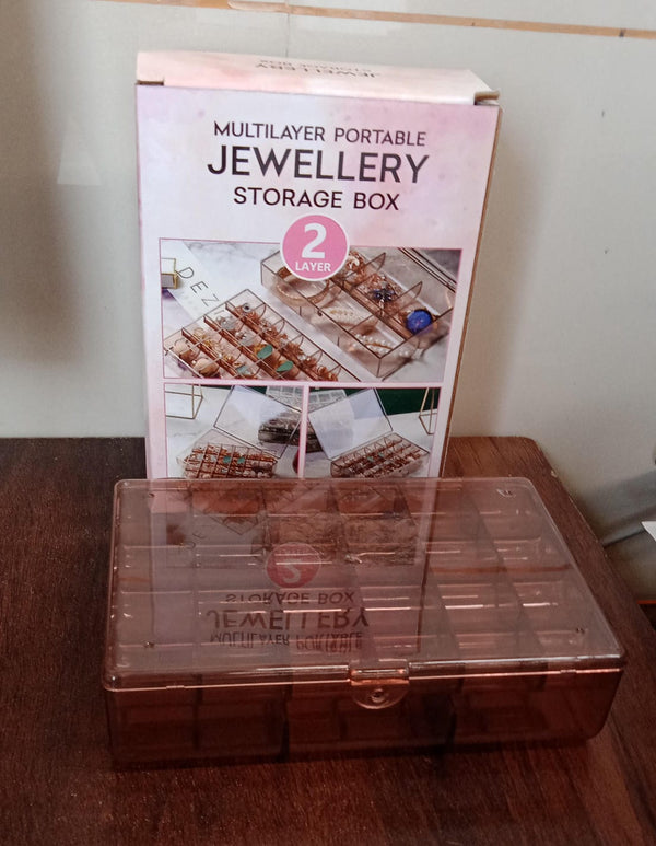 Compact clear acrylic storage box with a secure latch, showcasing its portability.