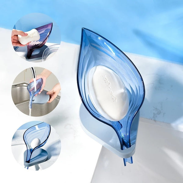 A green self-draining soap dish in a leaf shape, ready for use on a bathroom counter. Main image