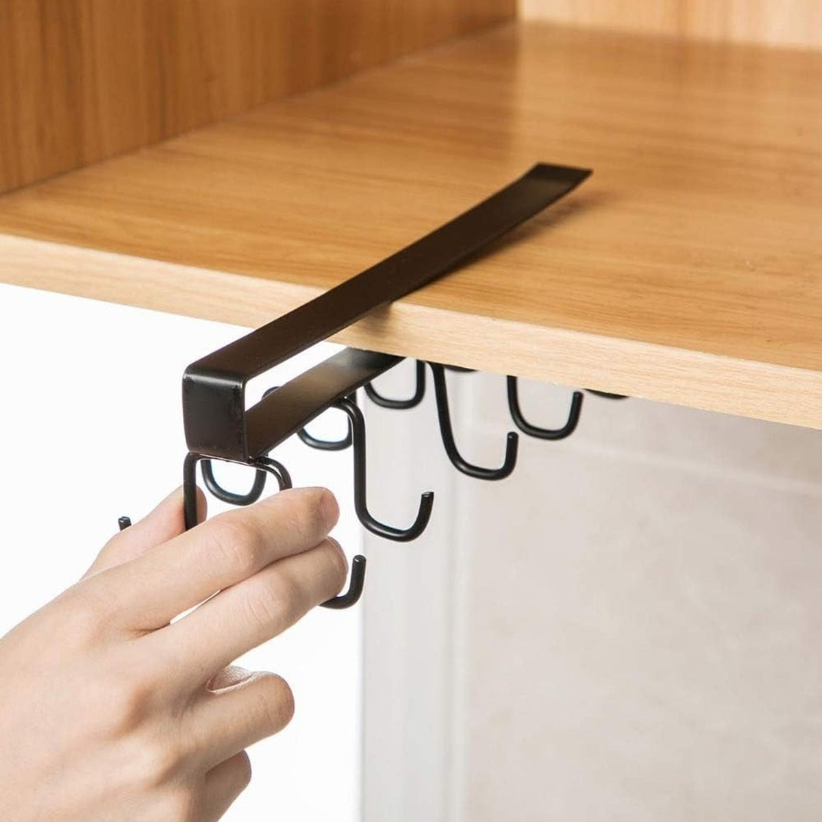 Double-row metal cup holder rack hanging mugs and cups in a modern kitchen. Main image