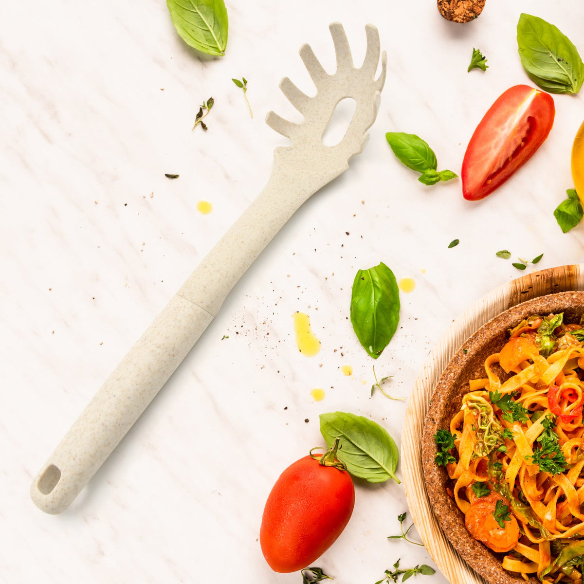 A black plastic pasta fork with serrated edges and a draining hole, ideal for serving spaghetti. Main image