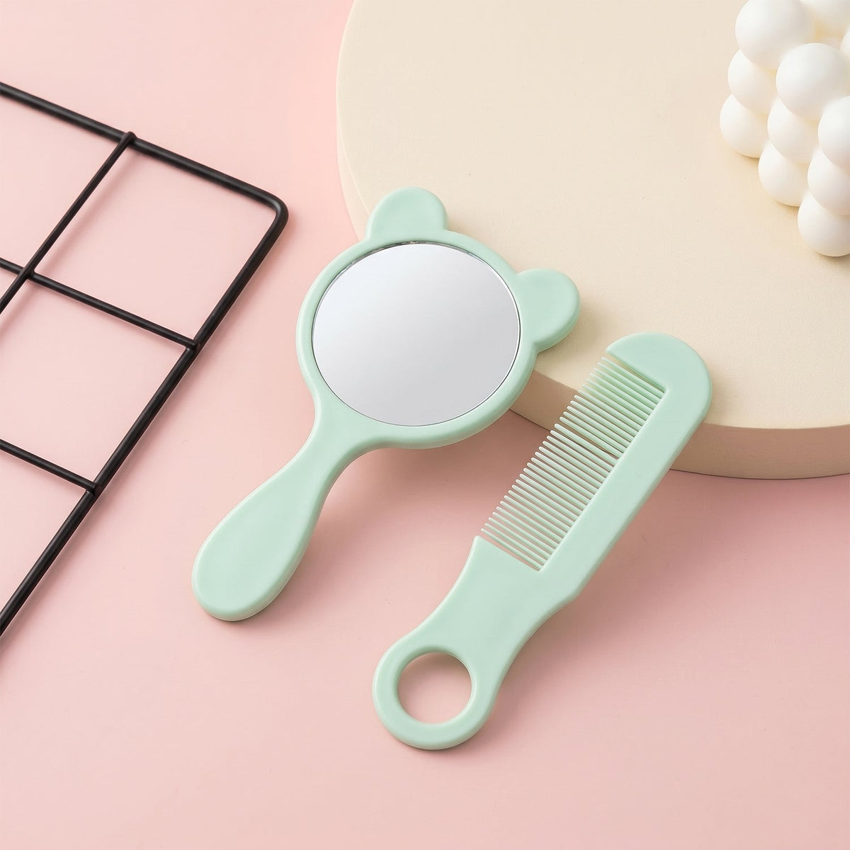 Cute bear-shaped handheld mirror in mint with matching comb in grooming kit Main image