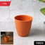 Durable plastic small drinking glass with tapered shape on white background