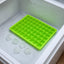 A white 60-Cavity Ice Tray ready to be filled, showcasing its compact design.
