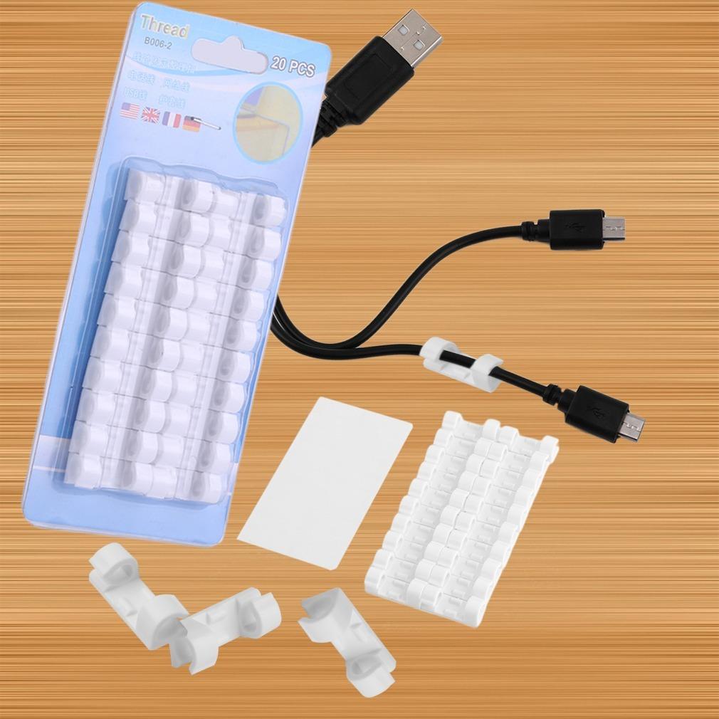 White self-adhesive cable clips arranged neatly on a clean surface. Main image