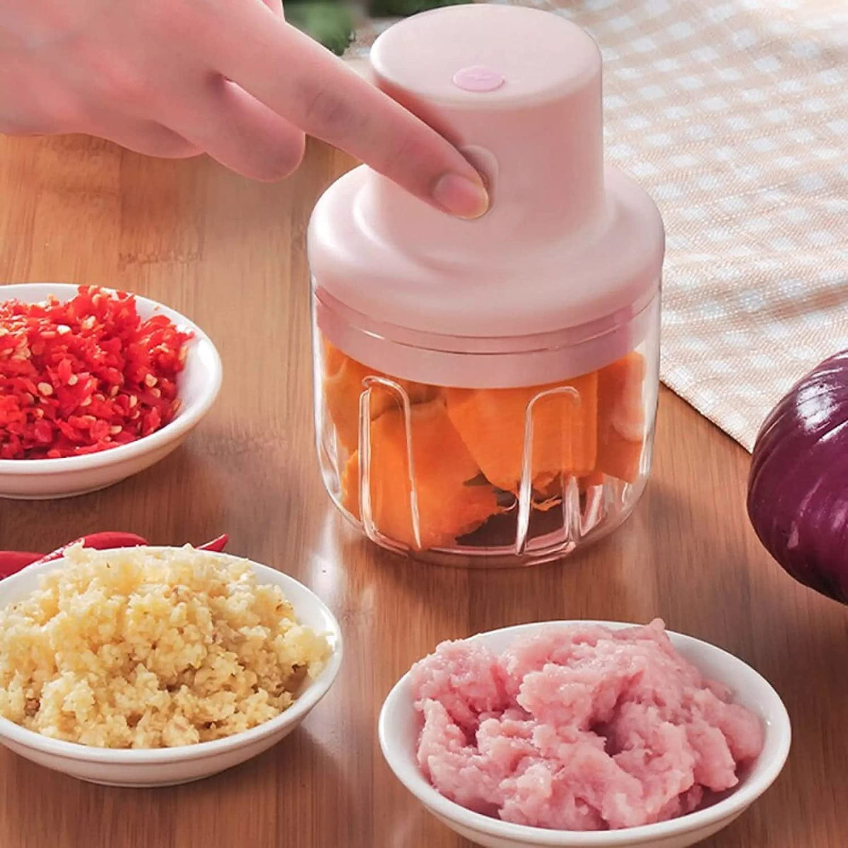 Top-down view of the Electric Mini Garlic Chopper with its lid and sharp stainless steel blade. Main image