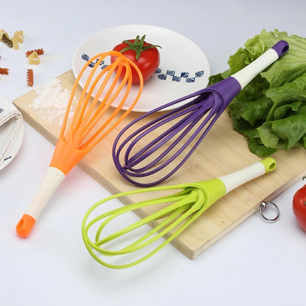 Ergonomic plastic balloon whisk for milk, coffee, and egg mixing by Quickslice. Main image