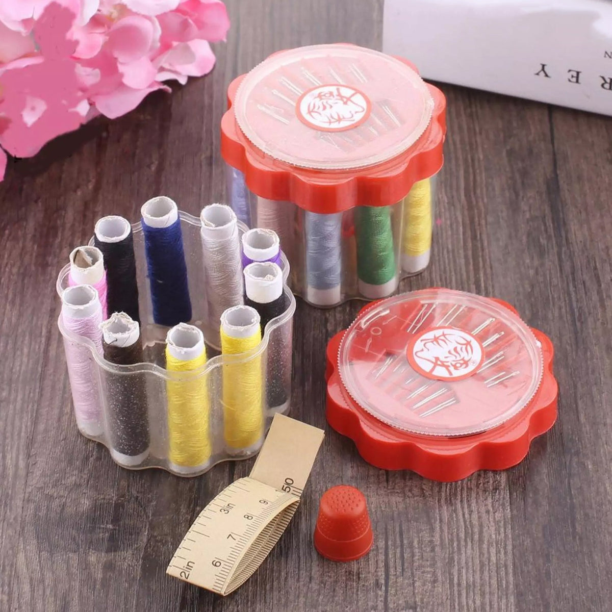 Compact sewing box open, revealing organized threads and sewing tools. Main image